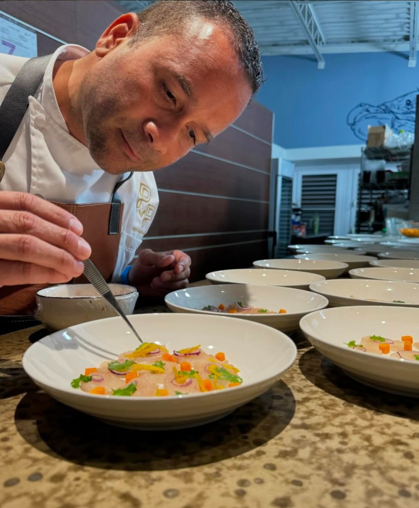 Chef Waldemar Marrero finishing a plate at the pass